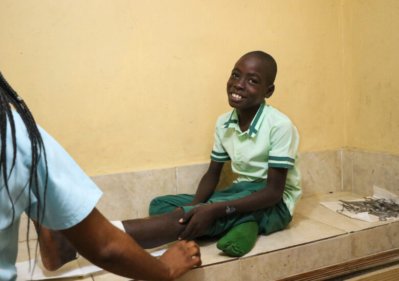 A young boy getting his leg checked out by a nurse at the clinic Sante 2000, in Haut Limbe, Haiti. 