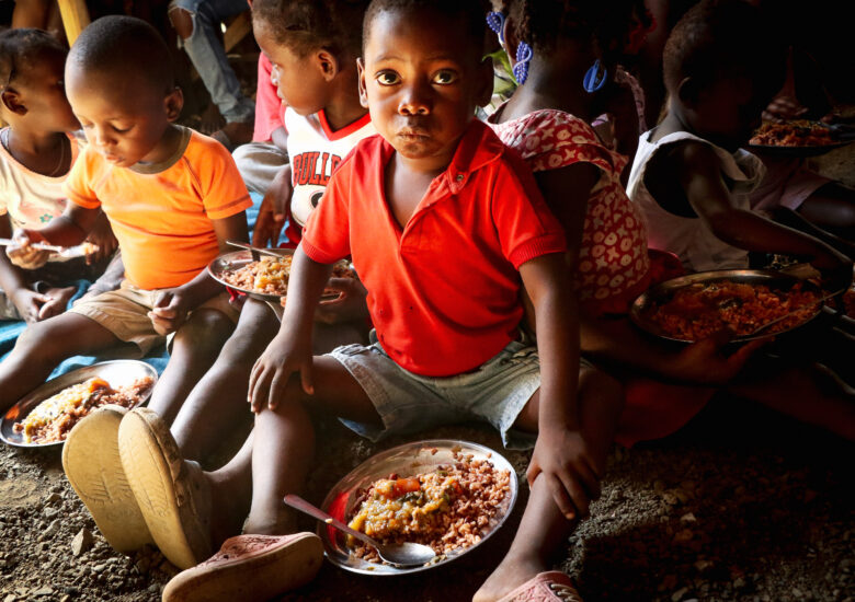 Children eating their meal at one of our feeding programs in Petite Anse, Haiti.